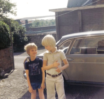 Me and Andrew Wall in the backyard outside 2 School Terrace, Summer 1980, with Star Wars figures on our shoulders. You can just about make out the A1 footbridge in the background. The beige Morris used to belong to my Grandad but we borrowed it