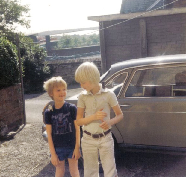 Me and Andrew Wall in the backyard outside 2 School Terrace, Summer 1980, with Star Wars figures on our shoulders. You can just about make out the A1 footbridge in the background. The beige Morris used to belong to my Grandad but we borrowed it